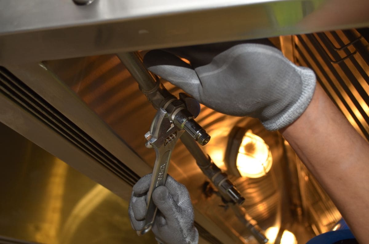 Heating engineer working on pipework during an emergency call-out